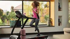 Woman runs on home treadmill