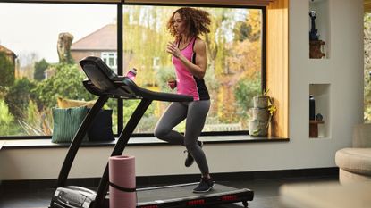 Woman runs on home treadmill