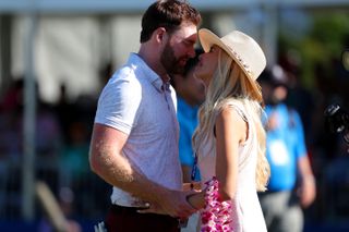 Grayson Murray and his fiancee kiss on the 18th green after winning the Sony Open
