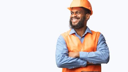 A man in a hardhat smiles.