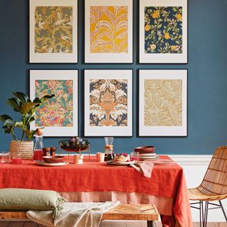 blue dining room with six framed pieces of wallpaper