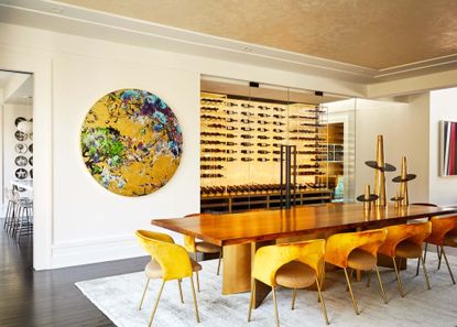 A wooden table paired with gold accessories on a grey rug