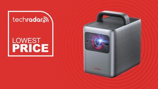 The Anker Nebula Cosmos 4K SE portable projector is pictured against a red background. Next to it, white text reads: lowest price.