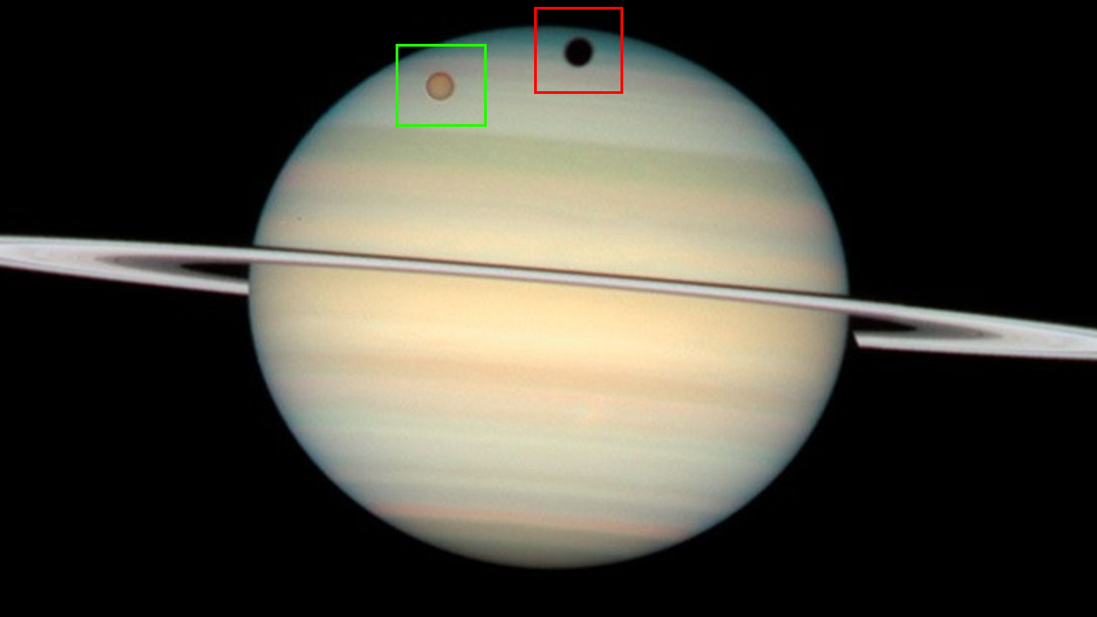 Photo of Saturn with Titan and its shadows across its surface