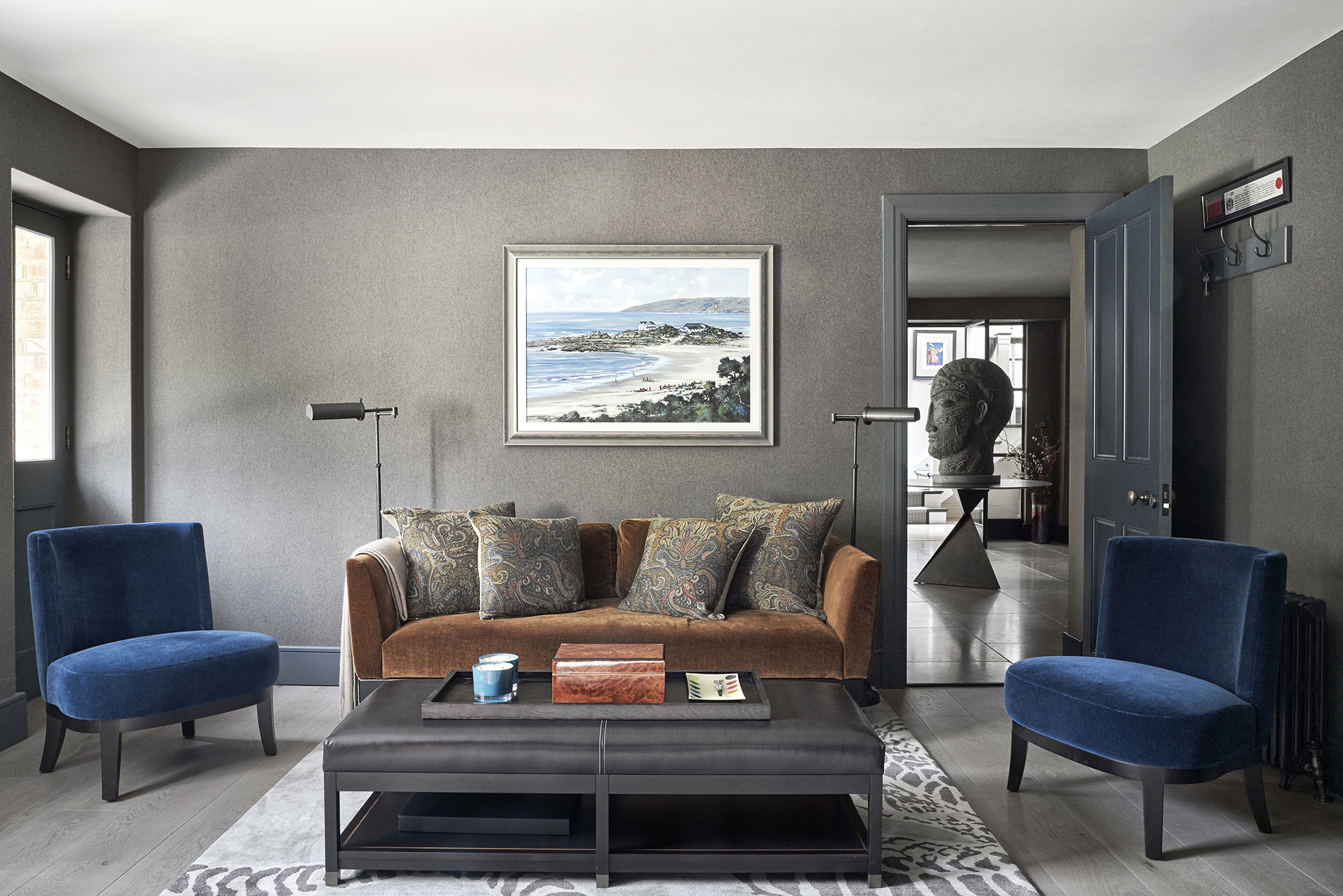 living room with grey walls and blue velvet chairs