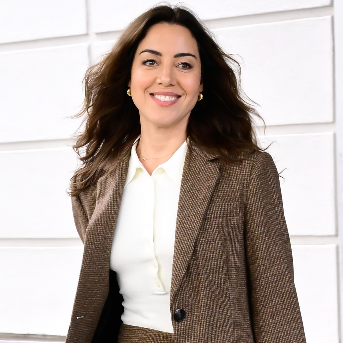 Aubrey Plaza is seen on October 08, 2025 in New York City wearinga. mini skirt, sheer tights, and brown leather loafers.