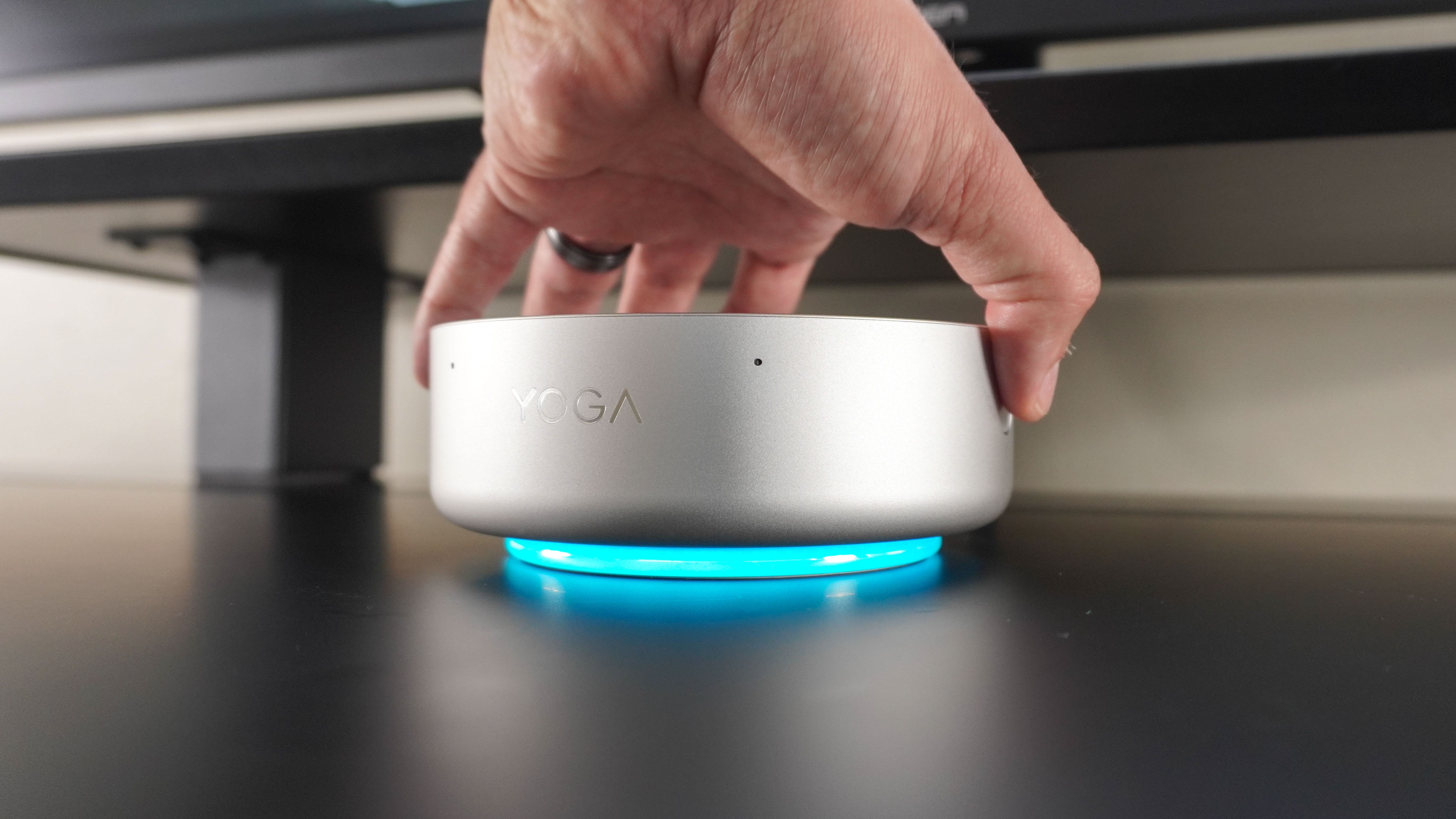 A person using the integrated fingerprint scanner in the Lenovo Yoga Mini to log into Windows