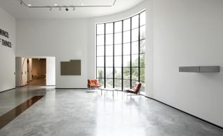 interior with large gridded window the modernist white painted and crips Fondation CAB in the south of France