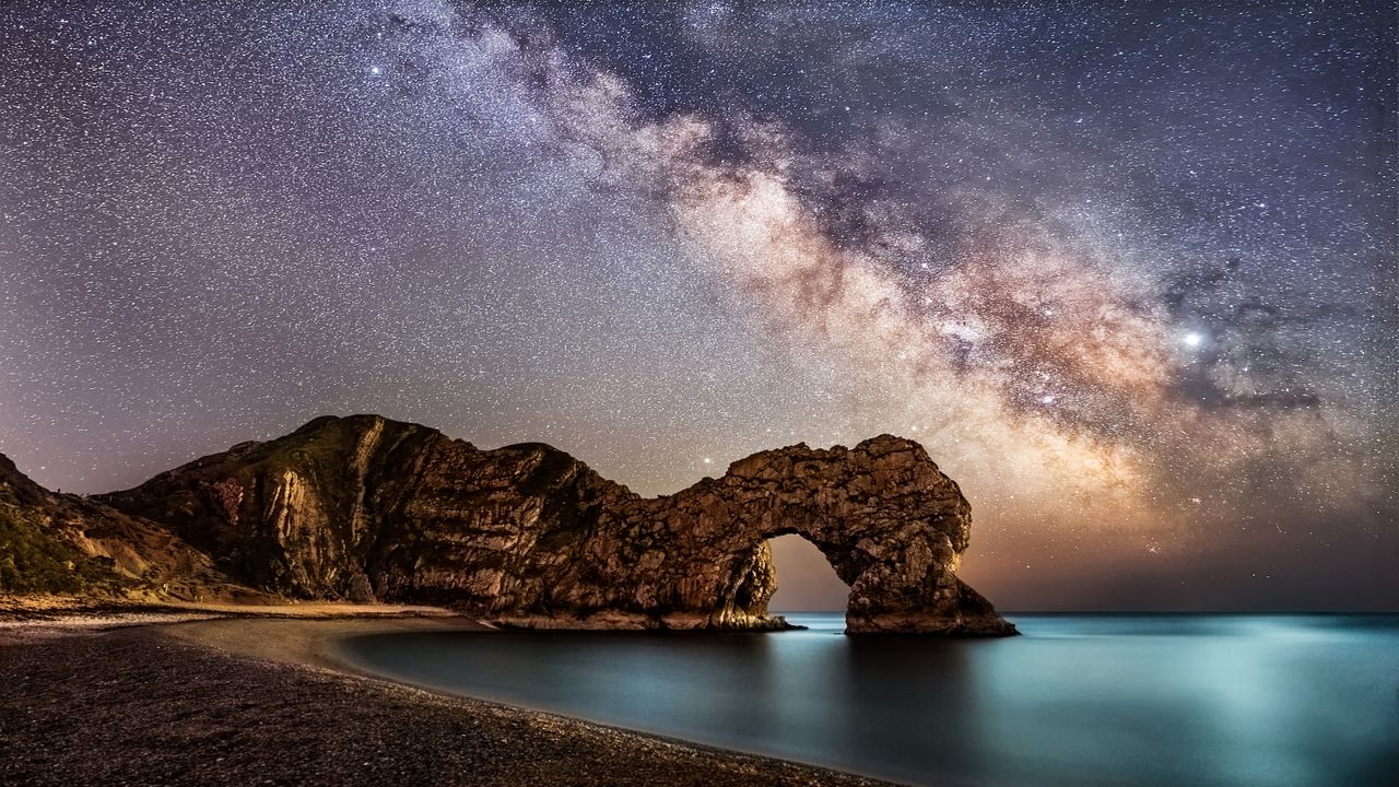 Milkyway in Dorset over durdle door at the jerassic coast beach - stock photo.