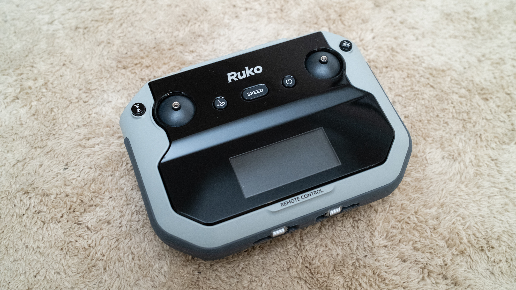 Ruko F11PRO 2 controller on a carpet