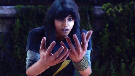 Kamala Khan stares in shock at her too-big hands in this screenshot of the Marvel's Avengers trailer