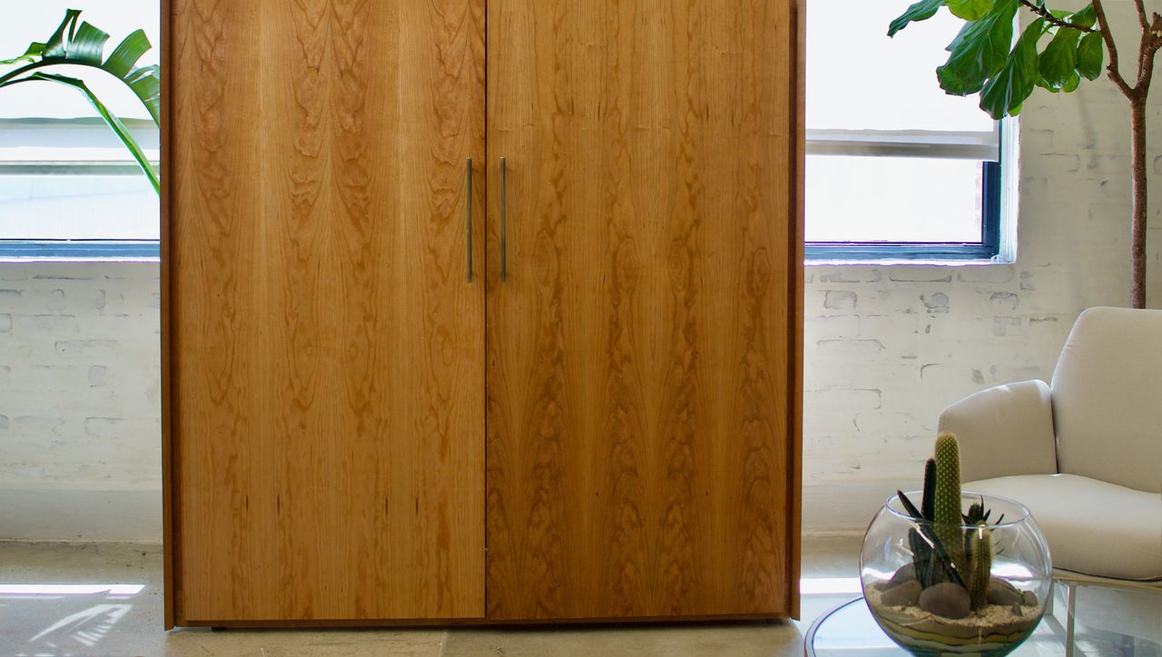 Boitier cupboard hiding a bike in a living room