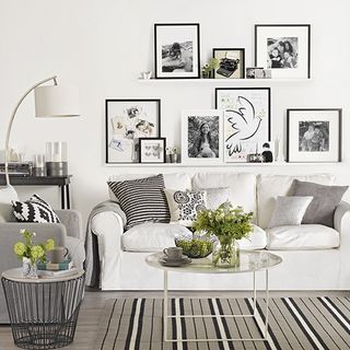 living area with white wall and white sofa