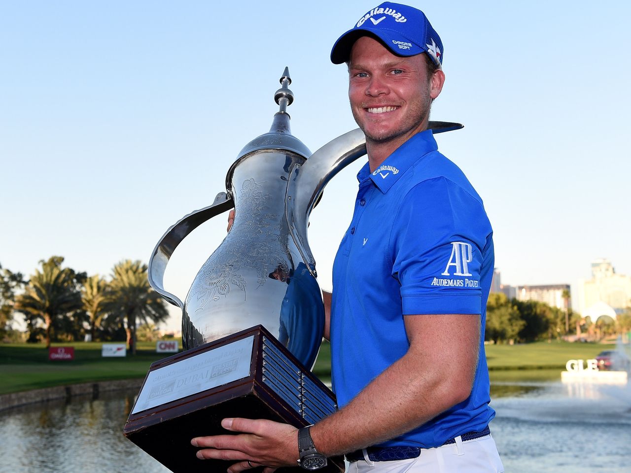 Danny Willett holds the Dubai Desert Classic trophy, after his one-shot win. Credit: Getty Images