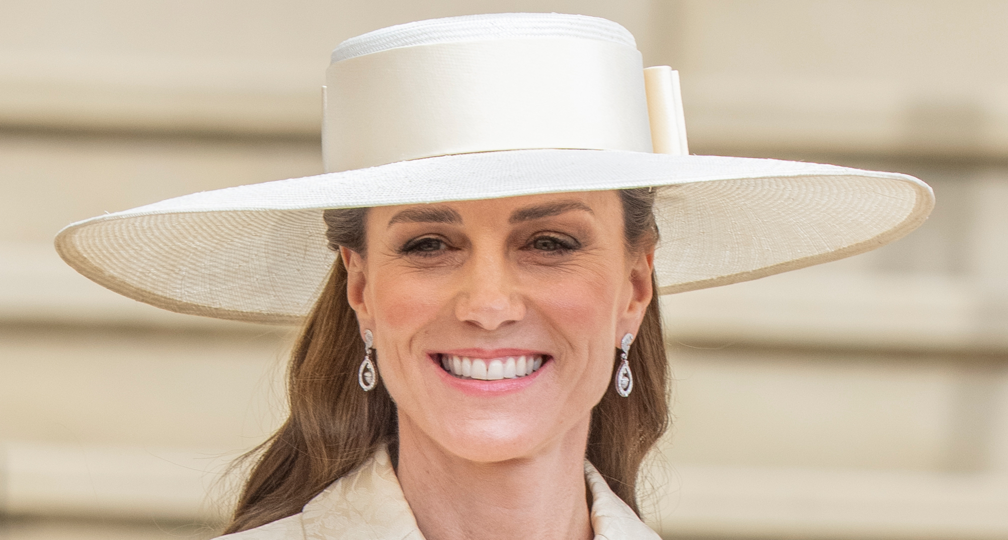 Princess Kate wearing a butter yellow coat and hat