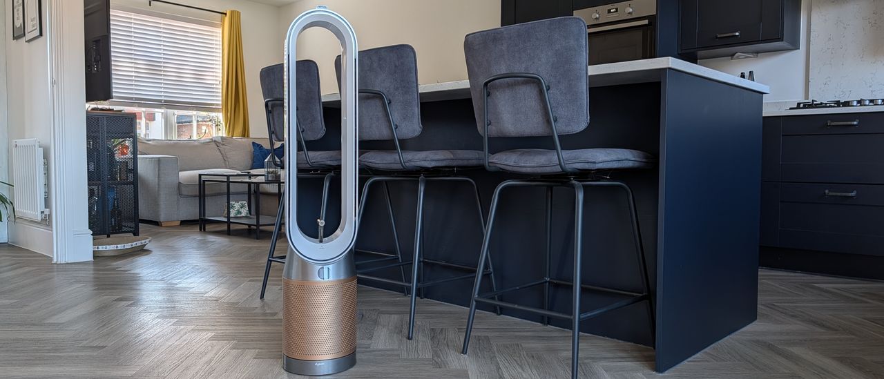 The Dyson Find+Follow Purifier Cool standing in someone's kitchen.