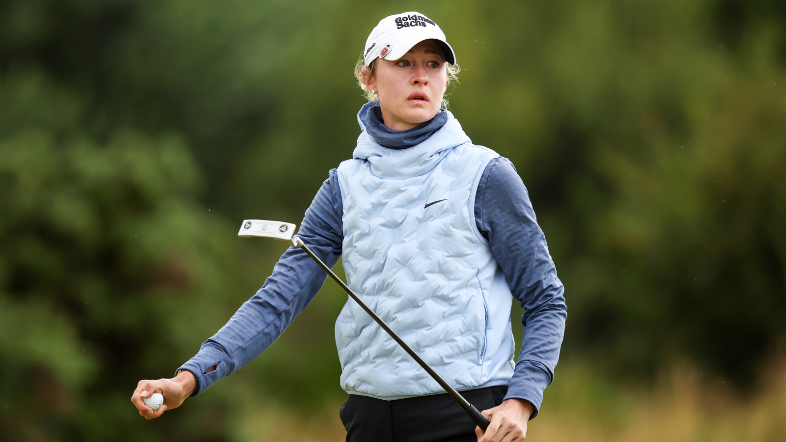 Nelly Korda walks off the green holding a putter