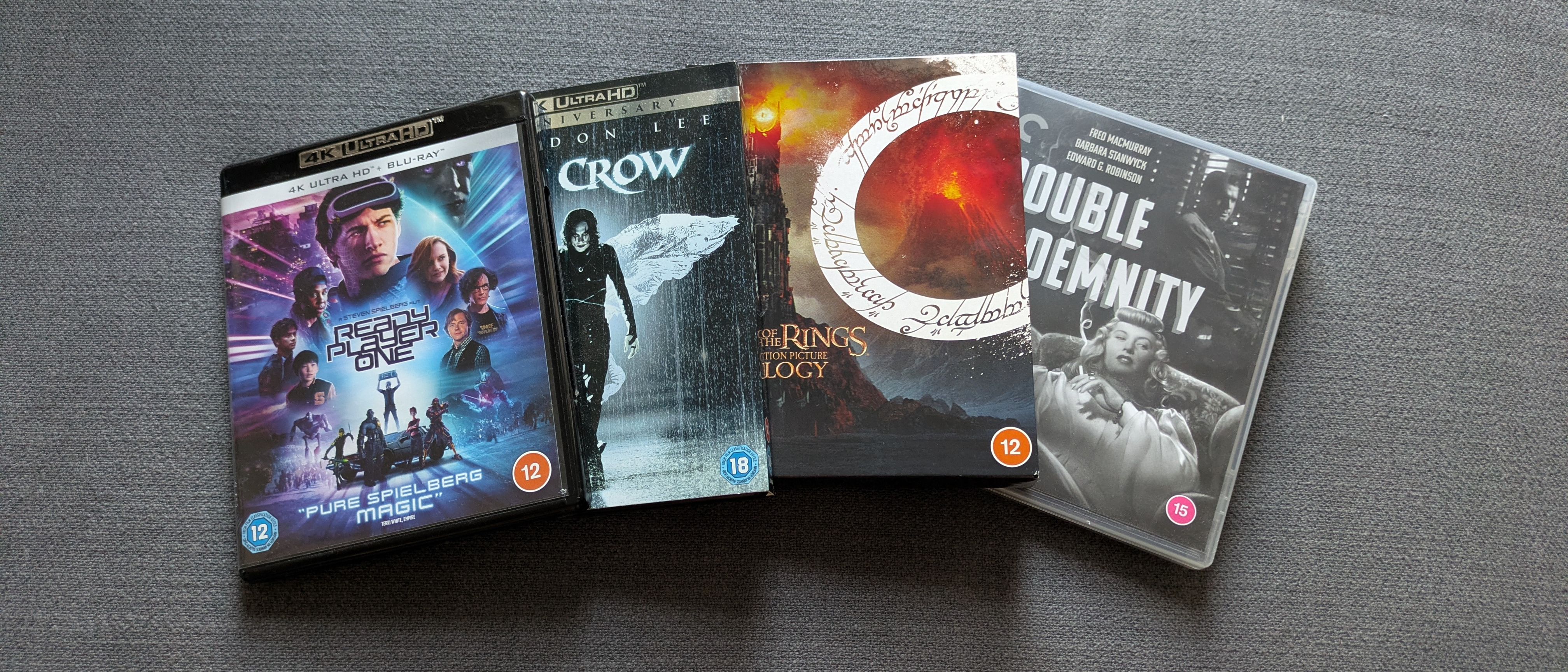 Four 4K Blu-ray cases in a line - Ready Player One, Lord of the rings, The Crow and Double Indemnity 