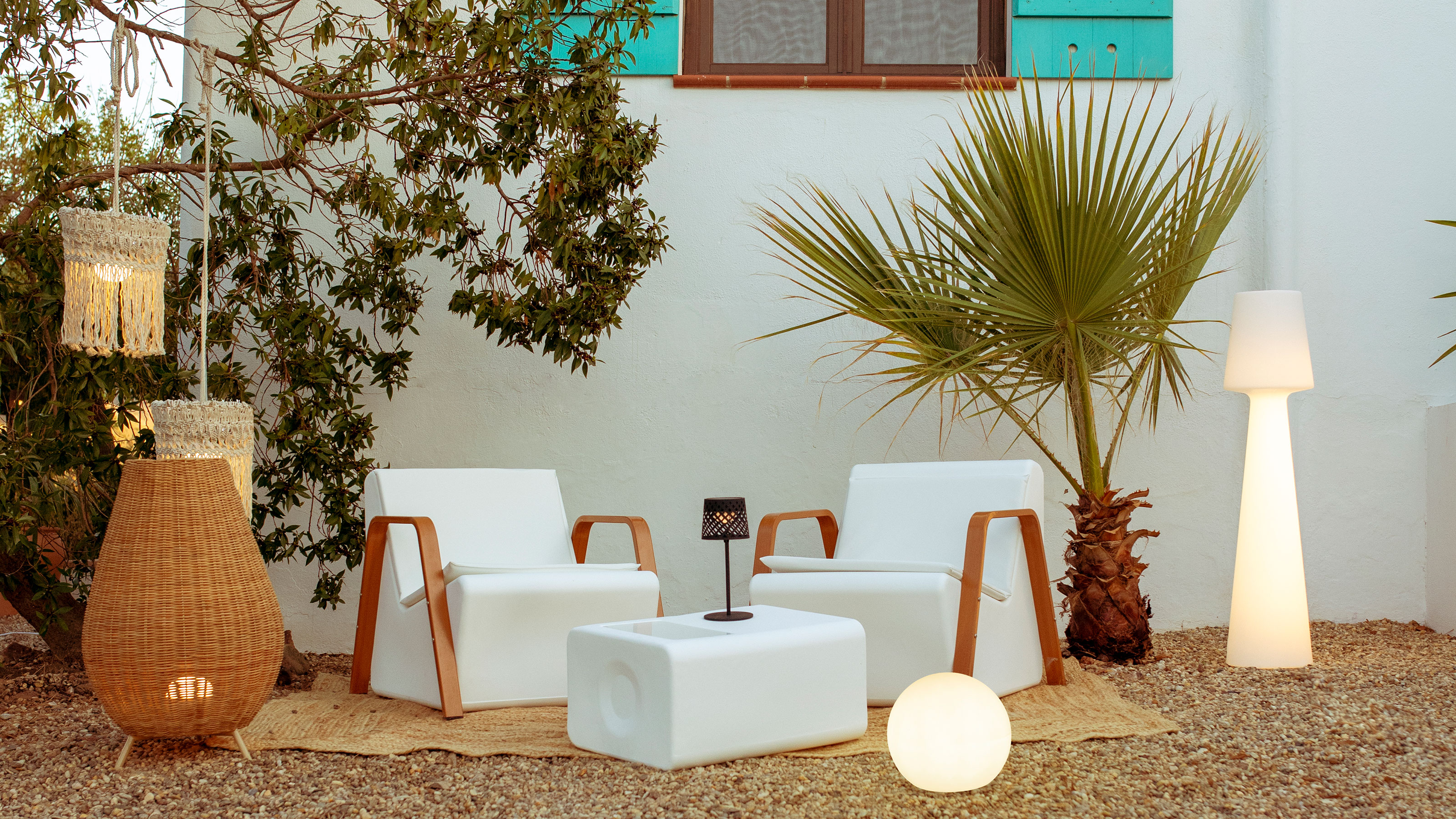 Mediterranean inspired garden with seating and array of outdoor light