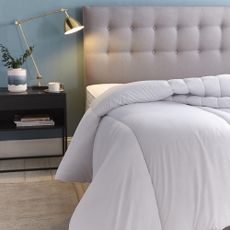 bedroom with white bedlinen and wooden flooring