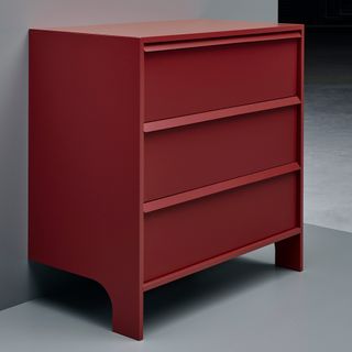 red cabinet with black and grey background with grey flooring