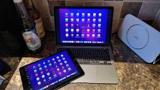 Macbook Air on a kitchen counter with an iPad next to it