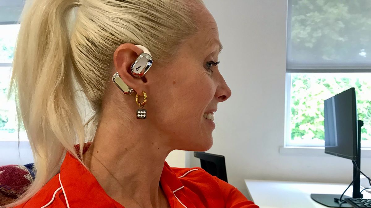 TechRadar senior audio writer Becky Scarrott wearing Oladance OWS in silver