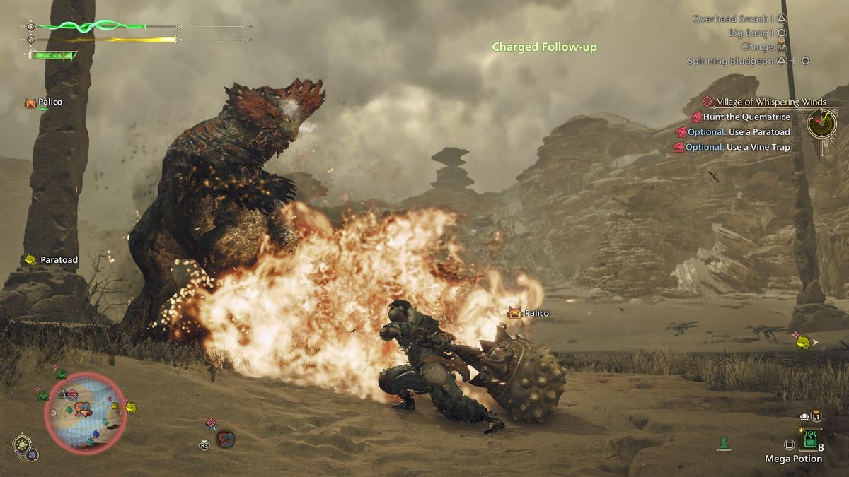 Performing an explosive hammer attack on an enemy in Monster Hunter Wilds in a sandy environment