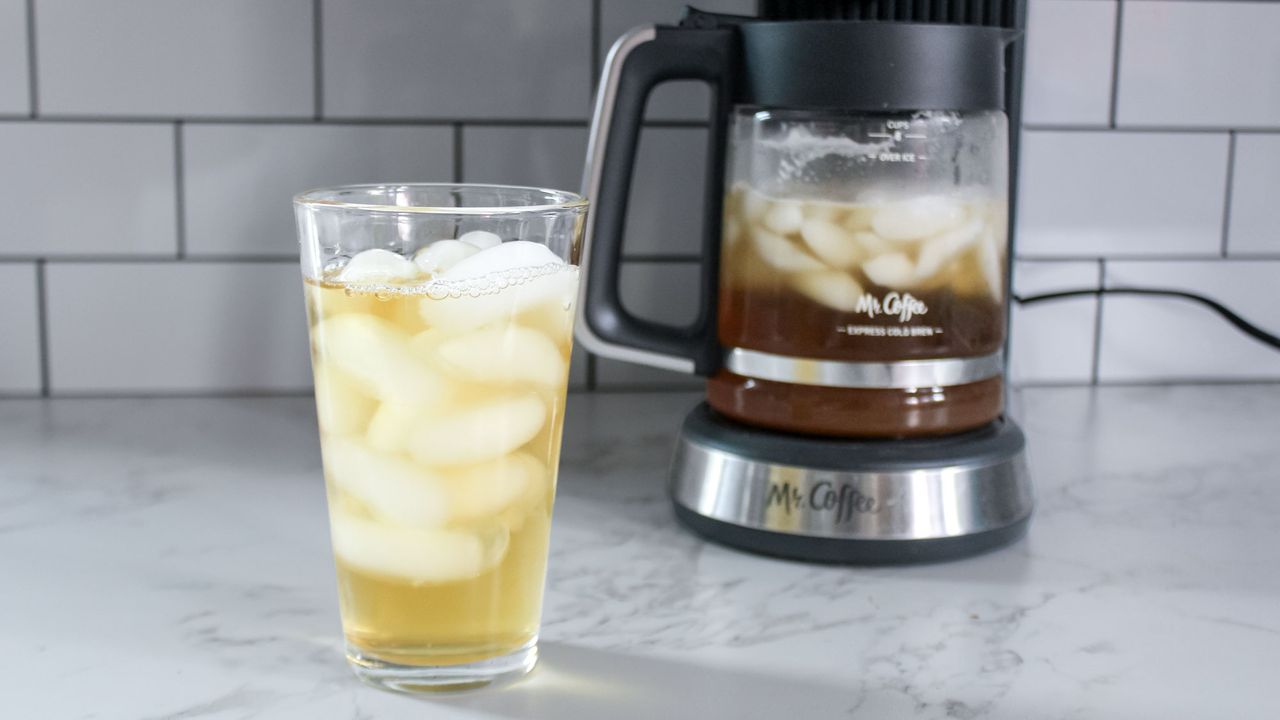 Mr. Coffee Perfect Brew Coffee Maker next to a glass of iced tea