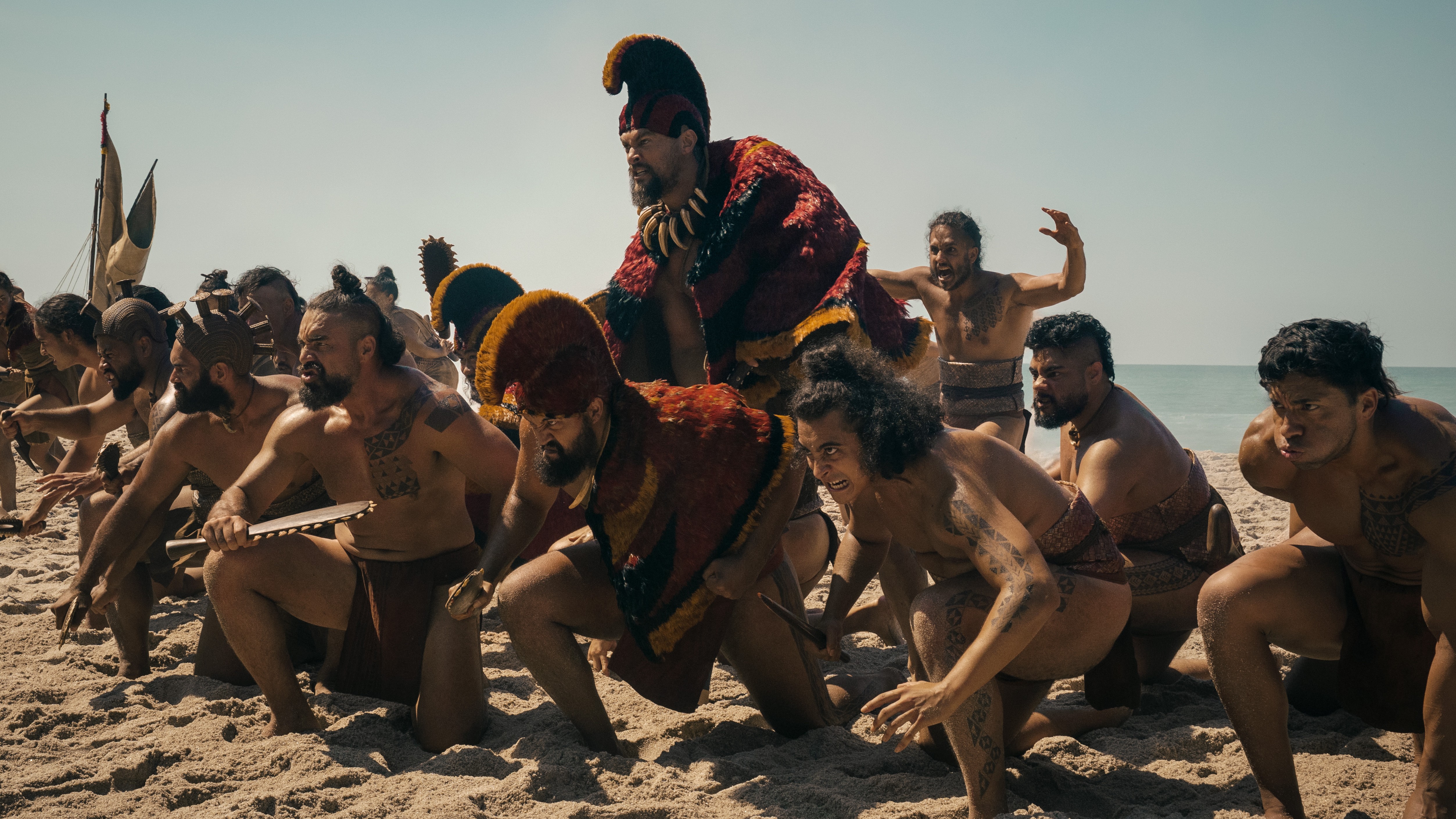 Jason Momoa and members of the "Chief of War" cast ready for battle in a scene from the Apple TV Plus Original