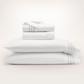 Boll & Branch Signature Embellished Sheet Set against a beige background.