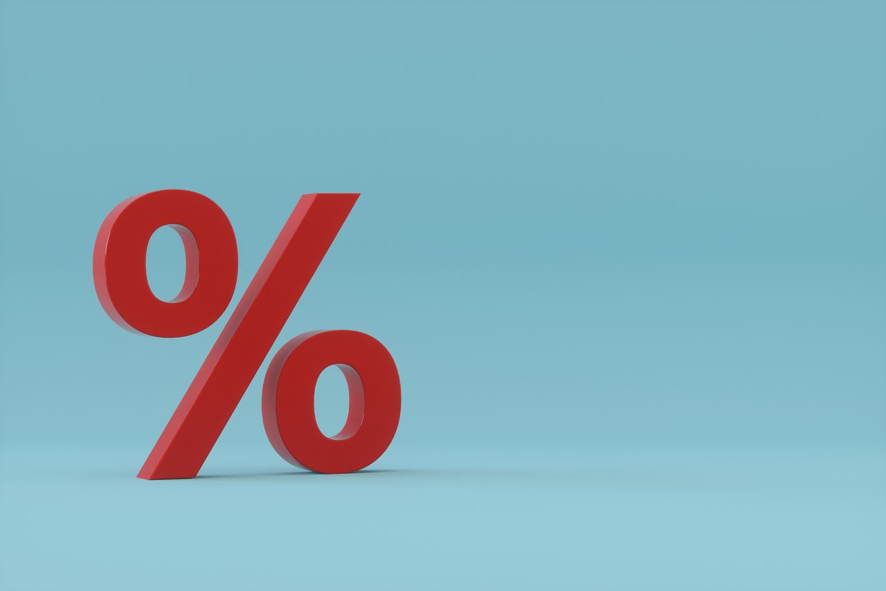 image of large red percent sign against light blue background