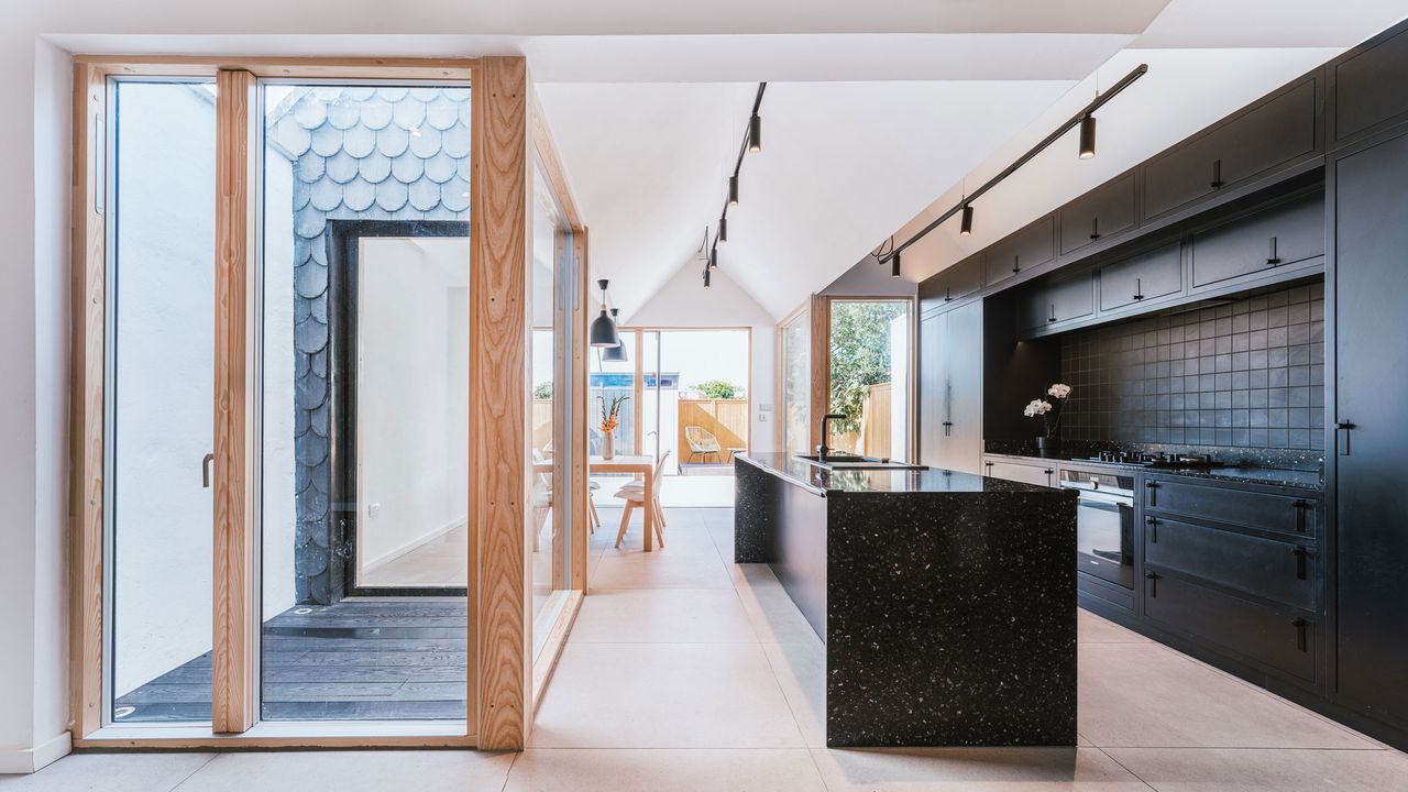 a black galley kitchen with internal courtyard