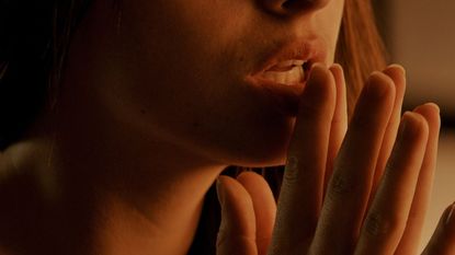 Woman provocatively touching her lips, scene from 'Fifty Shades of Grey'