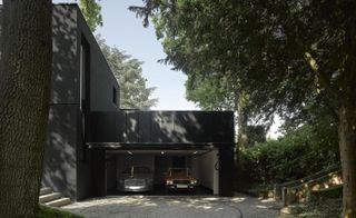 Winter House's impressive garage under the canopy of trees