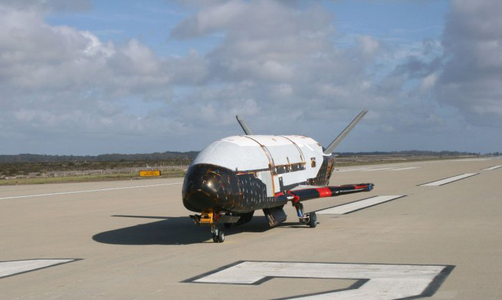 An image of the X-37B space plane prototype on a runway during flight tests by the United States Aur Force.