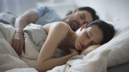 Sleep divorce: couple sleeping in bed