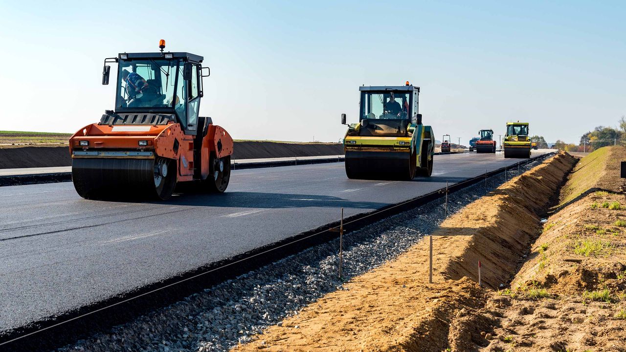 steamrollers repair a road