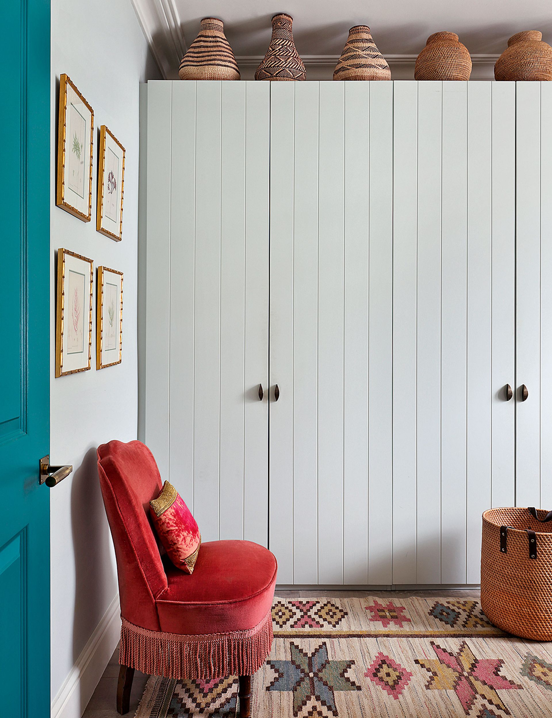 Small bedroom storage with white painted wardrobe and patterned rug