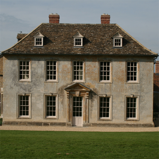 house exterior with white windows and garden lawn