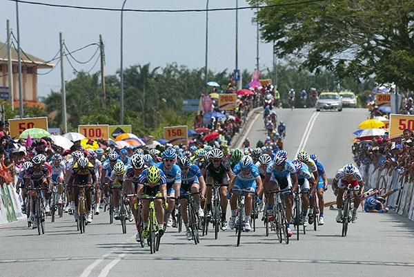 Italian Andrea Guardini (Farnese Vini) throws his bike at the line to win the third stage into Parit Sulong.