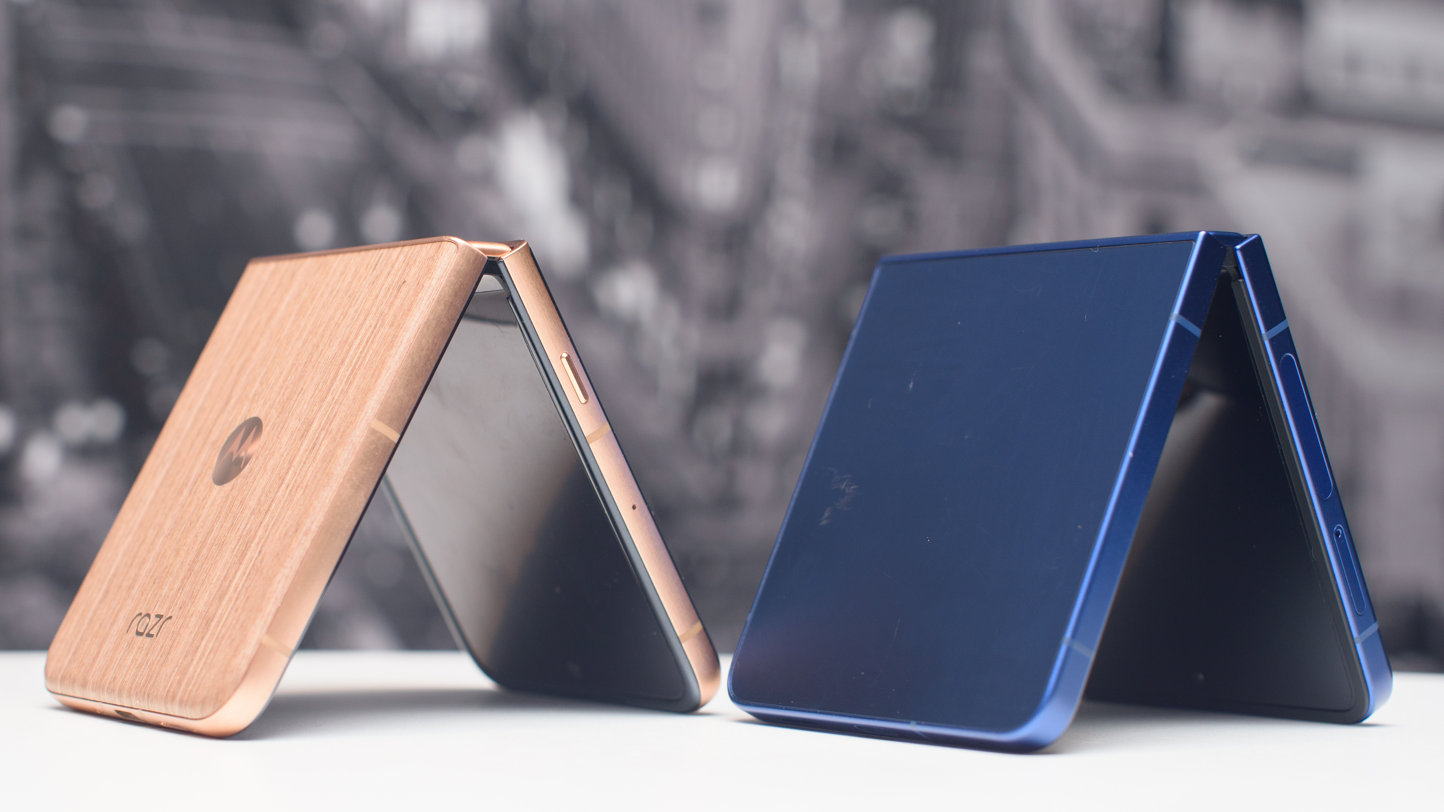 Samsung Galaxy Z Flip 7 in blue next. toa Motorola Razr Ultra 2025 in wood