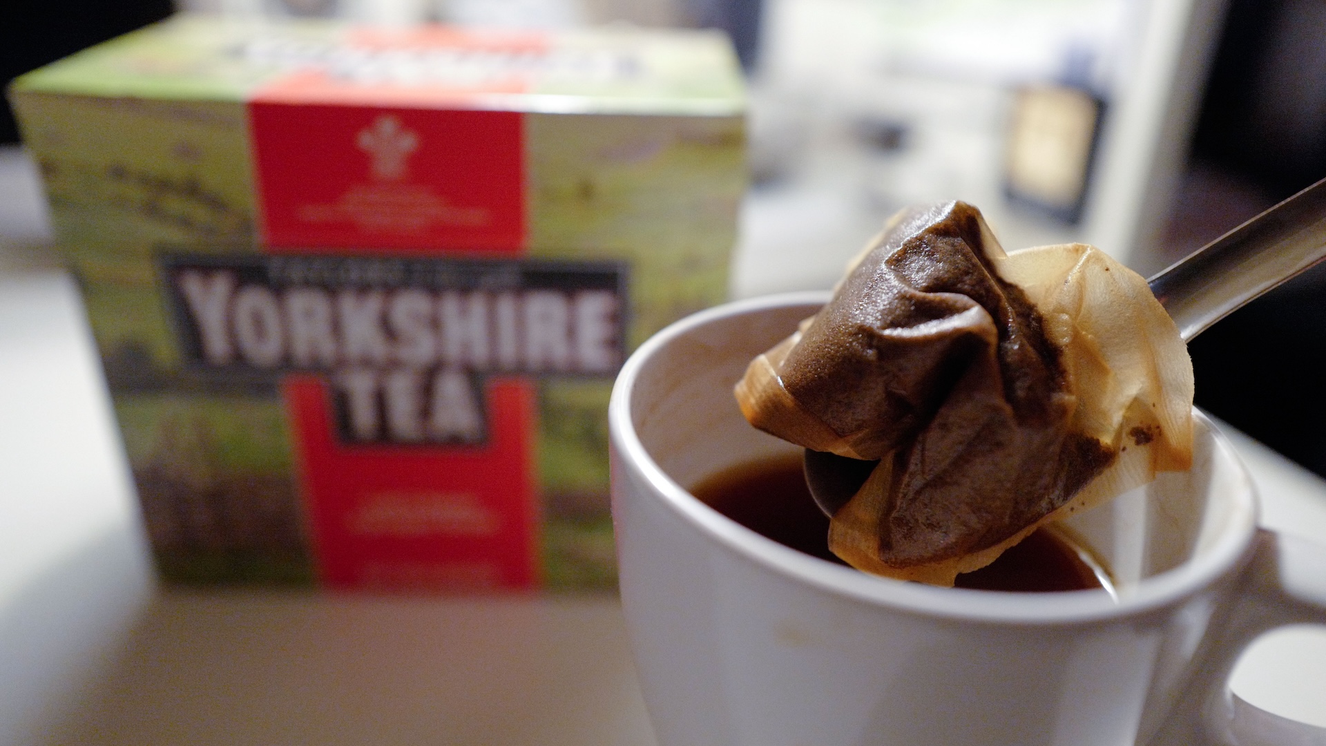 A man poses making a cup of tea with a Yorkshire Tea teabag with a box of tea in the background arranged as an illustration in London on December 19, 2018. - Britons are up in arms over new environmentally-friendly teabags that leave a bitter taste in the mouth as they split open, spilling their contents into teacups across the land. (Photo by Tolga AKMEN / AFP) (Photo credit should read TOLGA AKMEN/AFP via Getty Images)