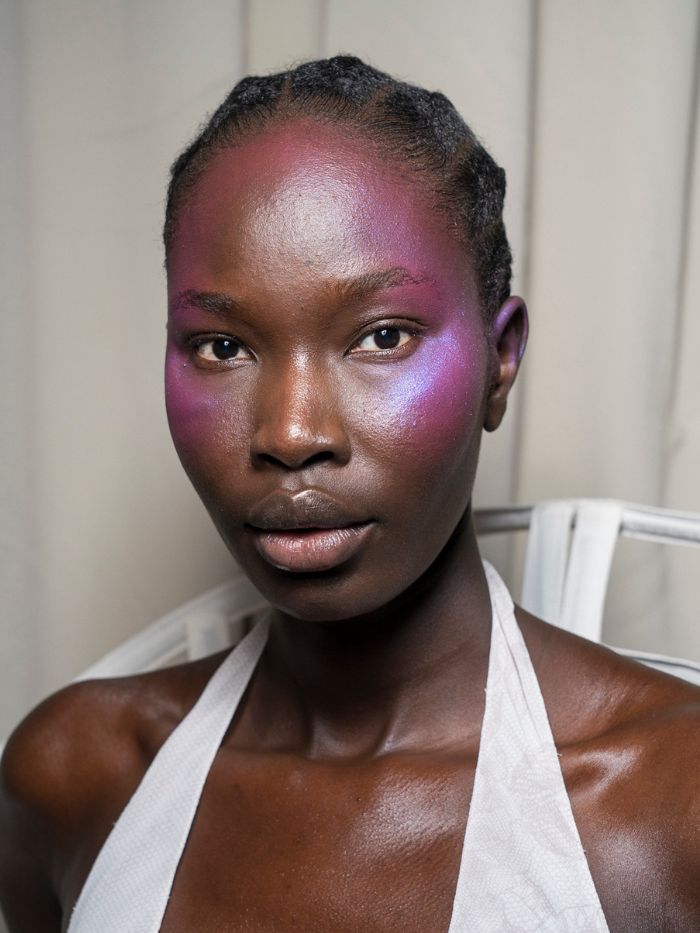 A close-up shot of the colourful makeup backstage at Harris Reed S/S 27
