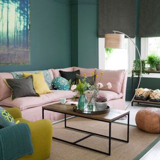 living room with teal green walls sofa set and cushions