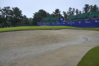 A bunker and green are flooded at the Toto Japan Classic