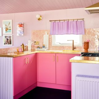 pink kitchen with brass handle and kitchen cabinet