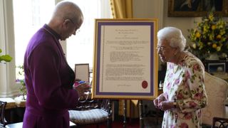 Queen Elizabeth II receives the Archbishop of Canterbury Justin Welby at Windsor Castle, where he presented her with a special 'Canterbury Cross' for her 'unstinting' service to the Church of England over seventy years and a citation for the Cross, which was presented as a framed piece of calligraphy on June 21, 2022 in Windsor, England.