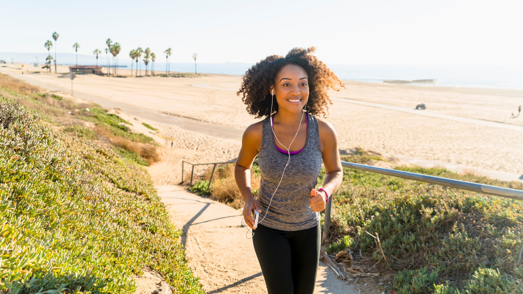 a photo of a woman running holding her phone