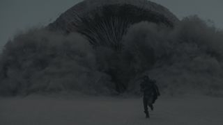 Paul Atreides tries to run away from a sandworm in Dune
